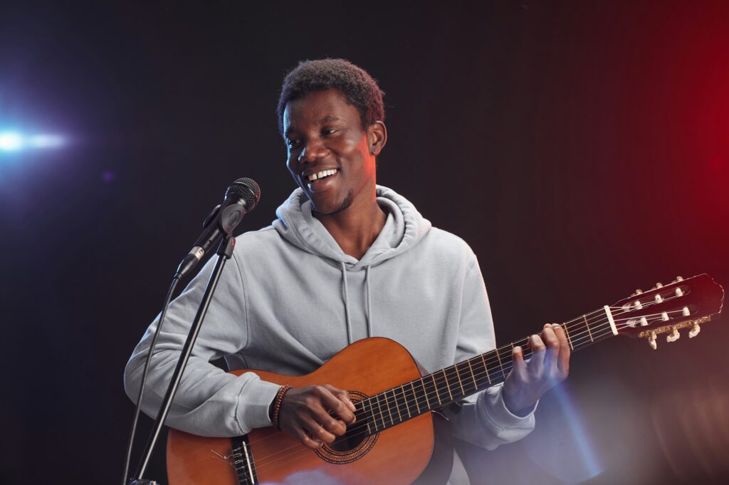 African-American Man Playing Guitar on Stage